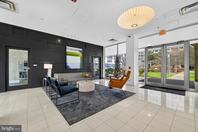 a living room with patio furniture and a large window