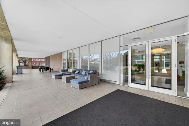 a living room with furniture and a large window with outer view