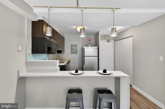 a bathroom with a sink a large mirror and vanity