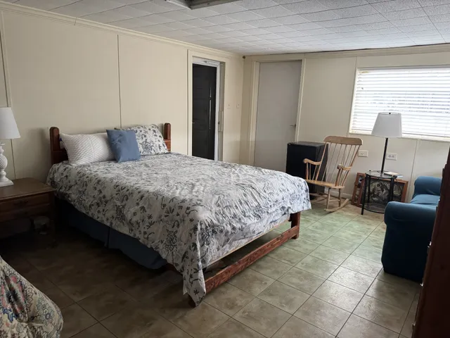 a bedroom with a bed and a couch