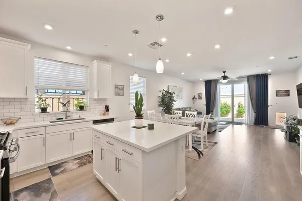 a kitchen with sink attached with living room