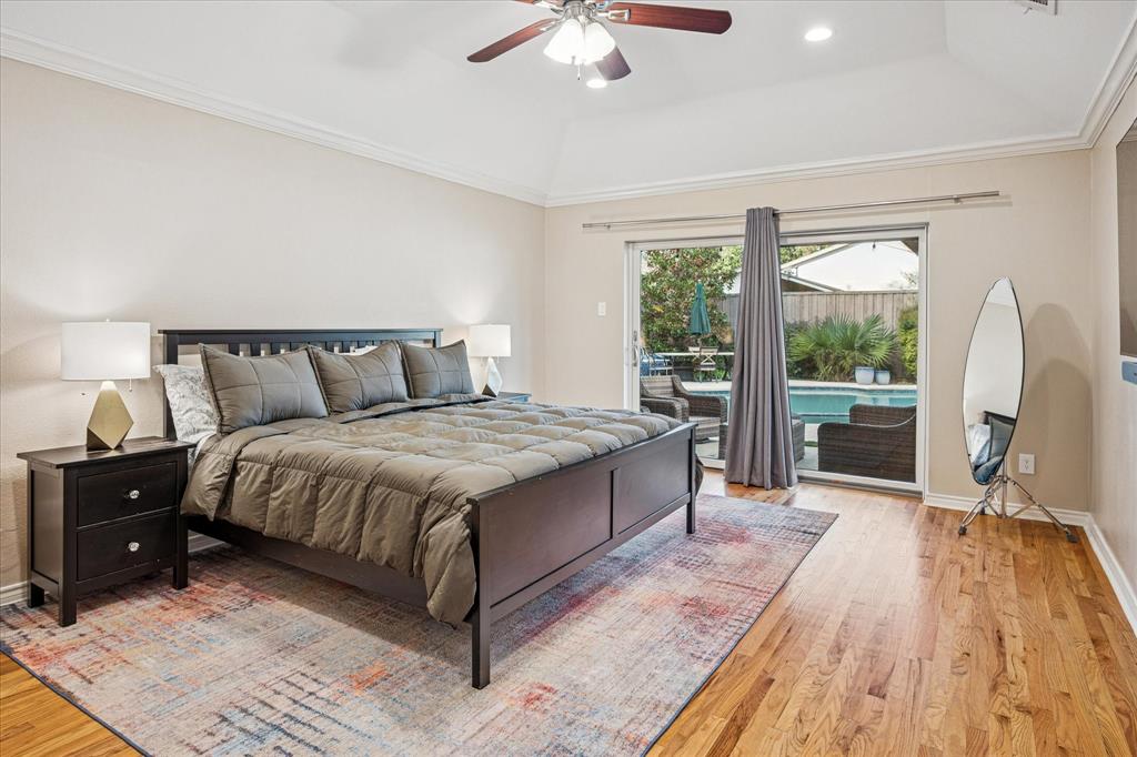 9545 Milltrail Drive Dallas, TX 75238 - Photo 11 of 30 a spacious bedroom with a bed and a large window