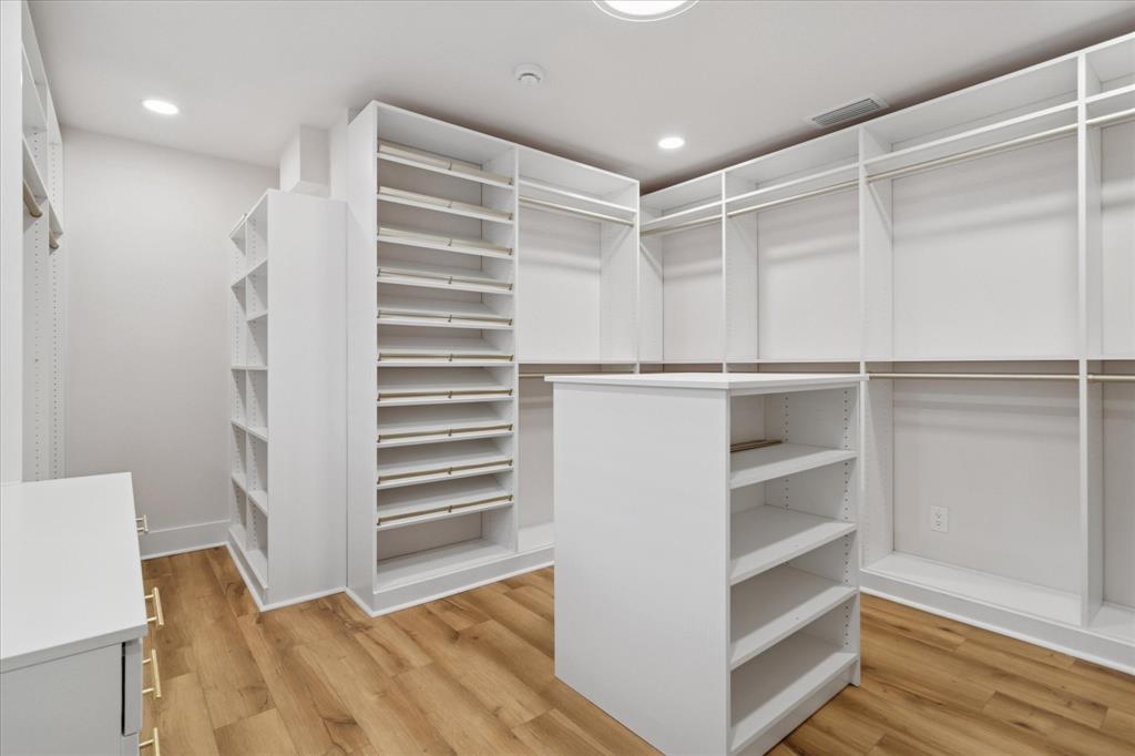 9545 Milltrail Drive Dallas, TX 75238 - Photo 12 of 30 a view of walk in closet with empty racks