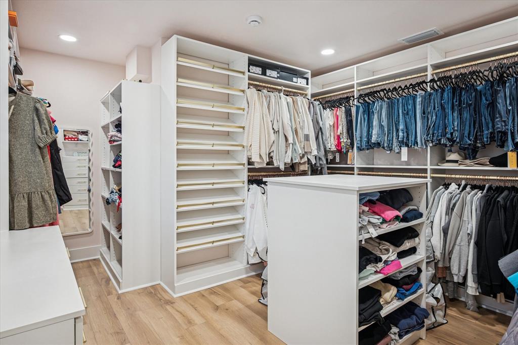 9545 Milltrail Drive Dallas, TX 75238 - Photo 13 of 30 a view of walk in closet with clothes and shoes