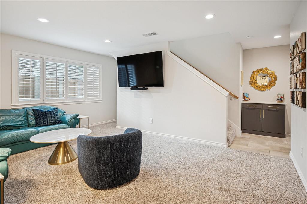 9545 Milltrail Drive Dallas, TX 75238 - Photo 22 of 30 a living room with furniture a flat screen tv and a large window