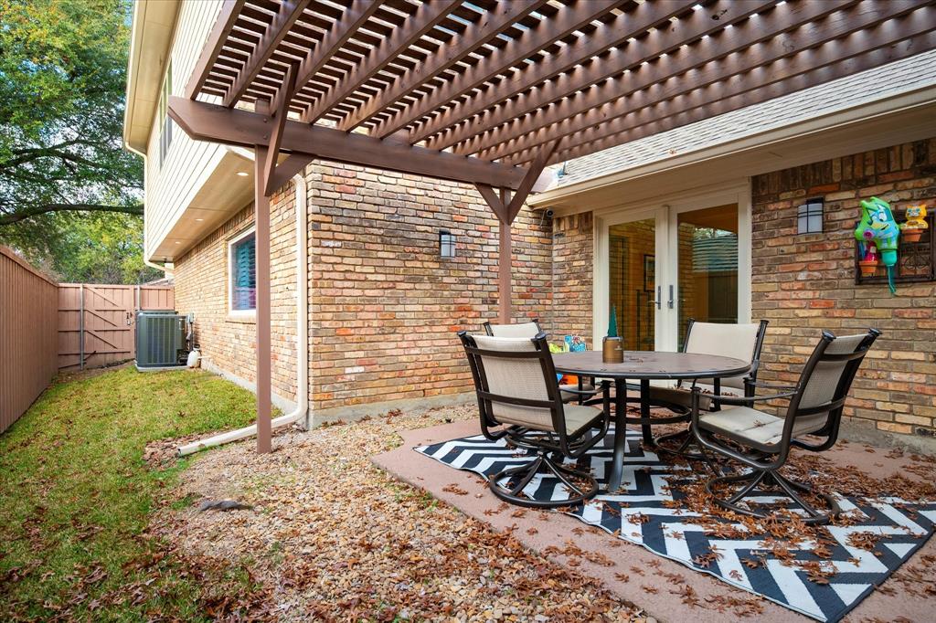 9545 Milltrail Drive Dallas, TX 75238 - Photo 25 of 30 a view of a patio with table and chairs and wooden floor