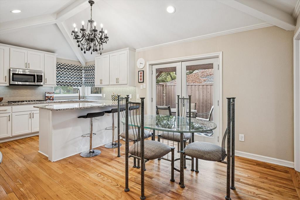 9545 Milltrail Drive Dallas, TX 75238 - Photo 4 of 30 a view of a dining room with furniture window and wooden floor
