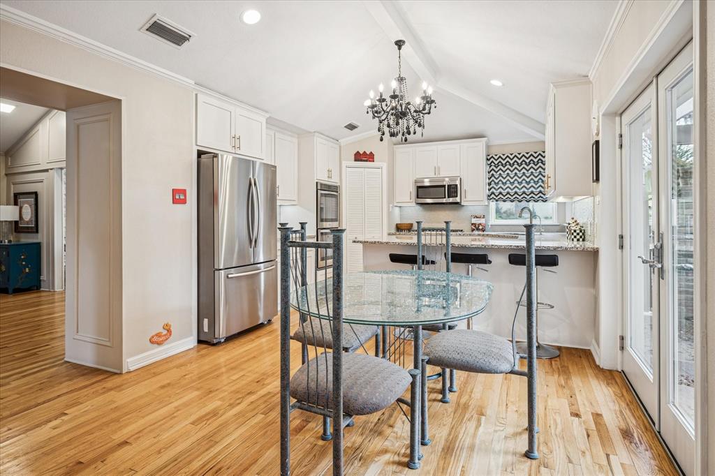 9545 Milltrail Drive Dallas, TX 75238 - Photo 5 of 30 a view of a dining room with furniture and wooden floor