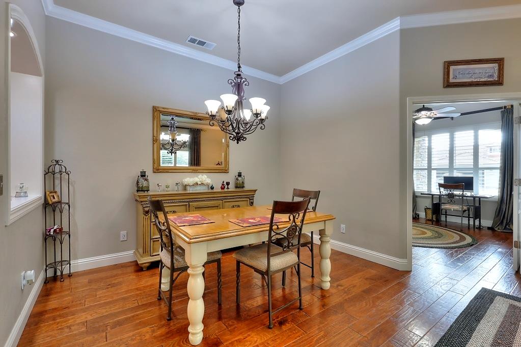 4152 Post Oak Drive Turlock, CA 95382 - Photo 19 of 71 a dining room with furniture wooden floor a chandelier and a rug