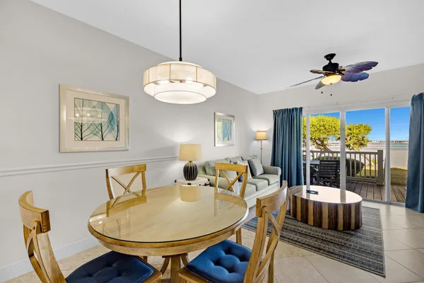 a dining room with furniture a chandelier and window