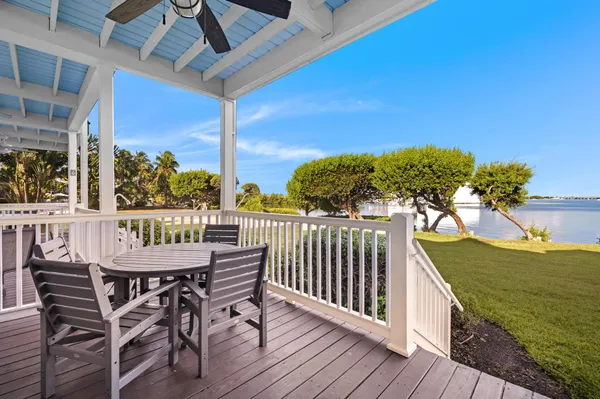 a view of a chairs and table in patio with wooden floor
