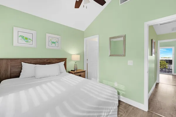 a bedroom with a bed and painting on the wall