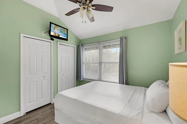 a bedroom with a bed and a tv