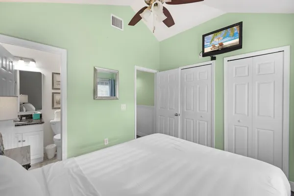 a bedroom with a bed and a chandelier