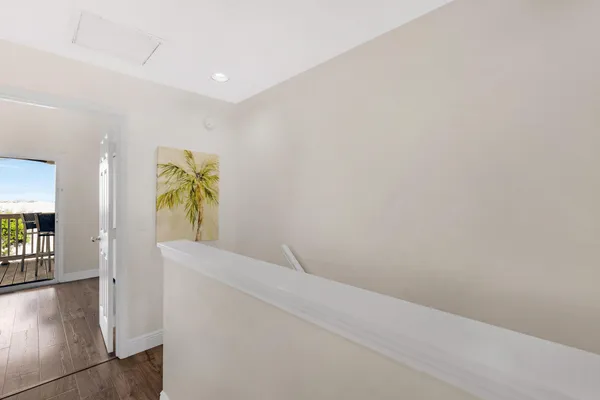 a view of hallway with furniture and a potted plant