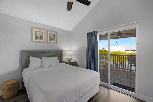 a bedroom with a balcony and large window