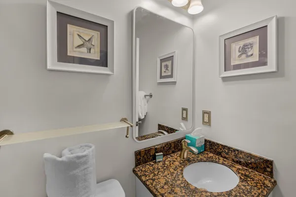 a bathroom with a granite countertop sink and a mirror