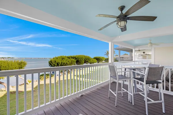 a view of a balcony dining area with wooden floor