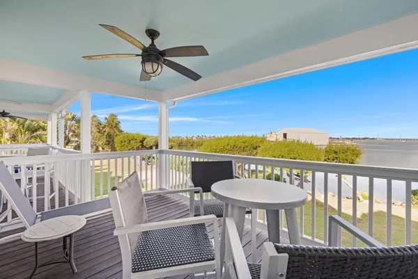 a view of a balcony with a table and chairs