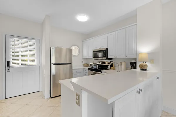 a kitchen with a refrigerator a stove a microwave and island