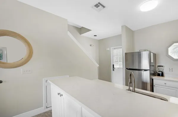 a kitchen with a refrigerator and a sink