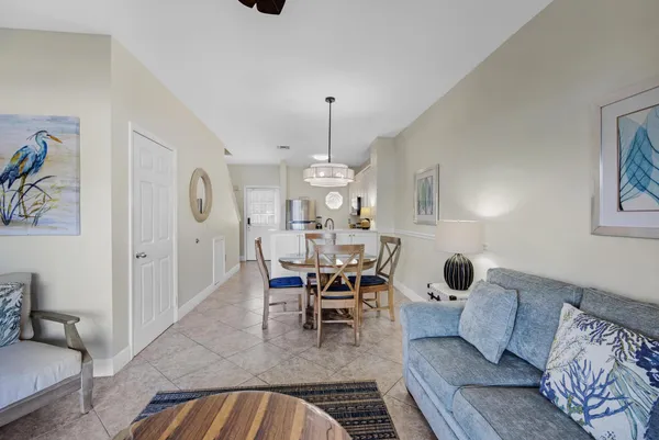 a dining room with furniture and a chandelier