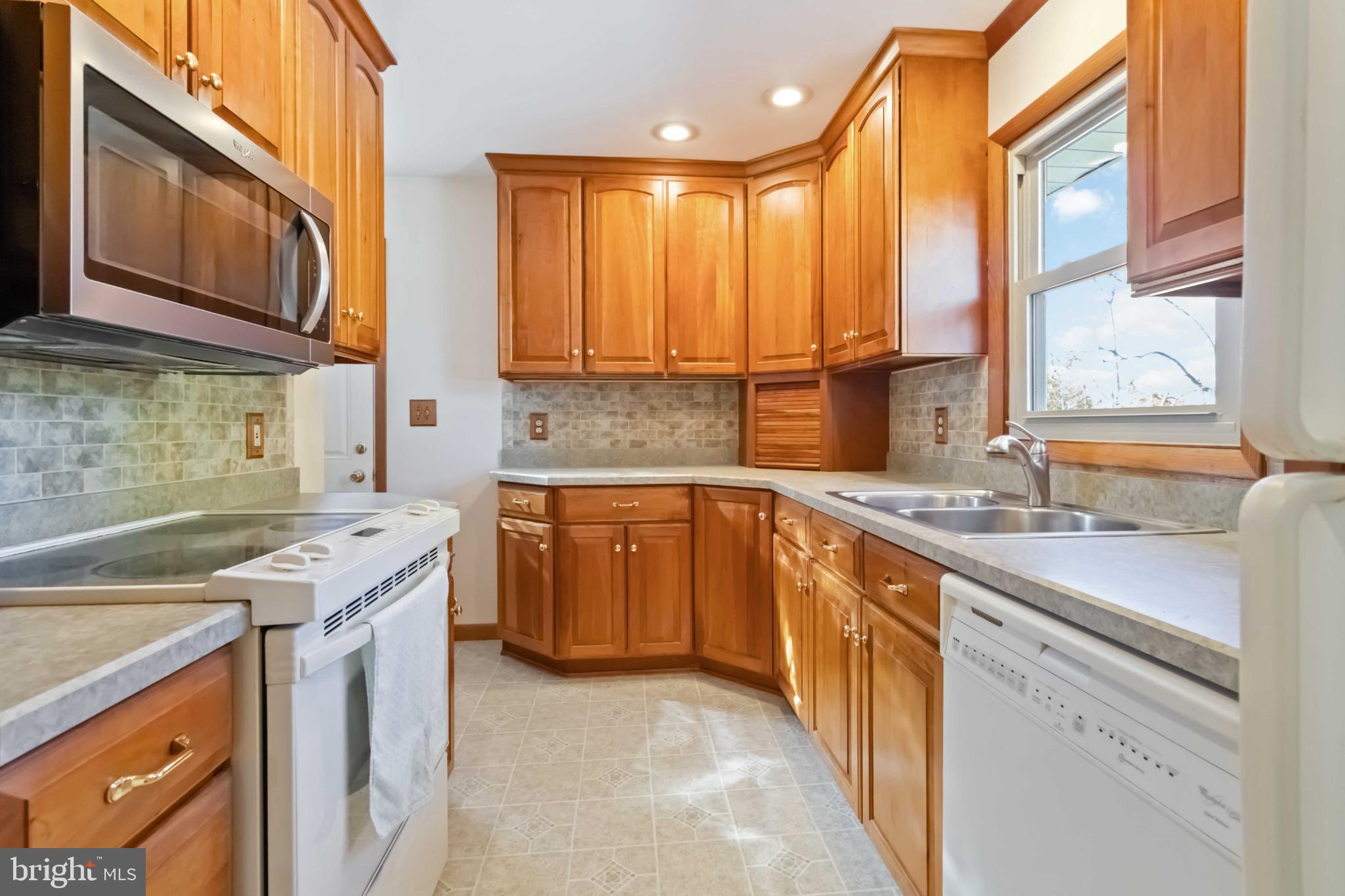 6216 Blue Grass Avenue Harrisburg, PA 17112 - Photo 11 of 23 a kitchen with a sink stove top oven and cabinets