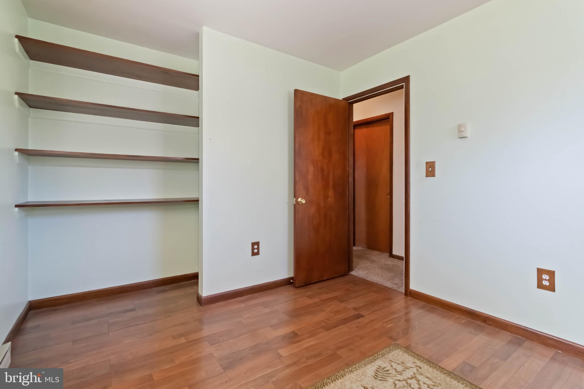 6216 Blue Grass Avenue Harrisburg, PA 17112 - Photo 16 of 23 a view of an empty room with wooden floor and closet