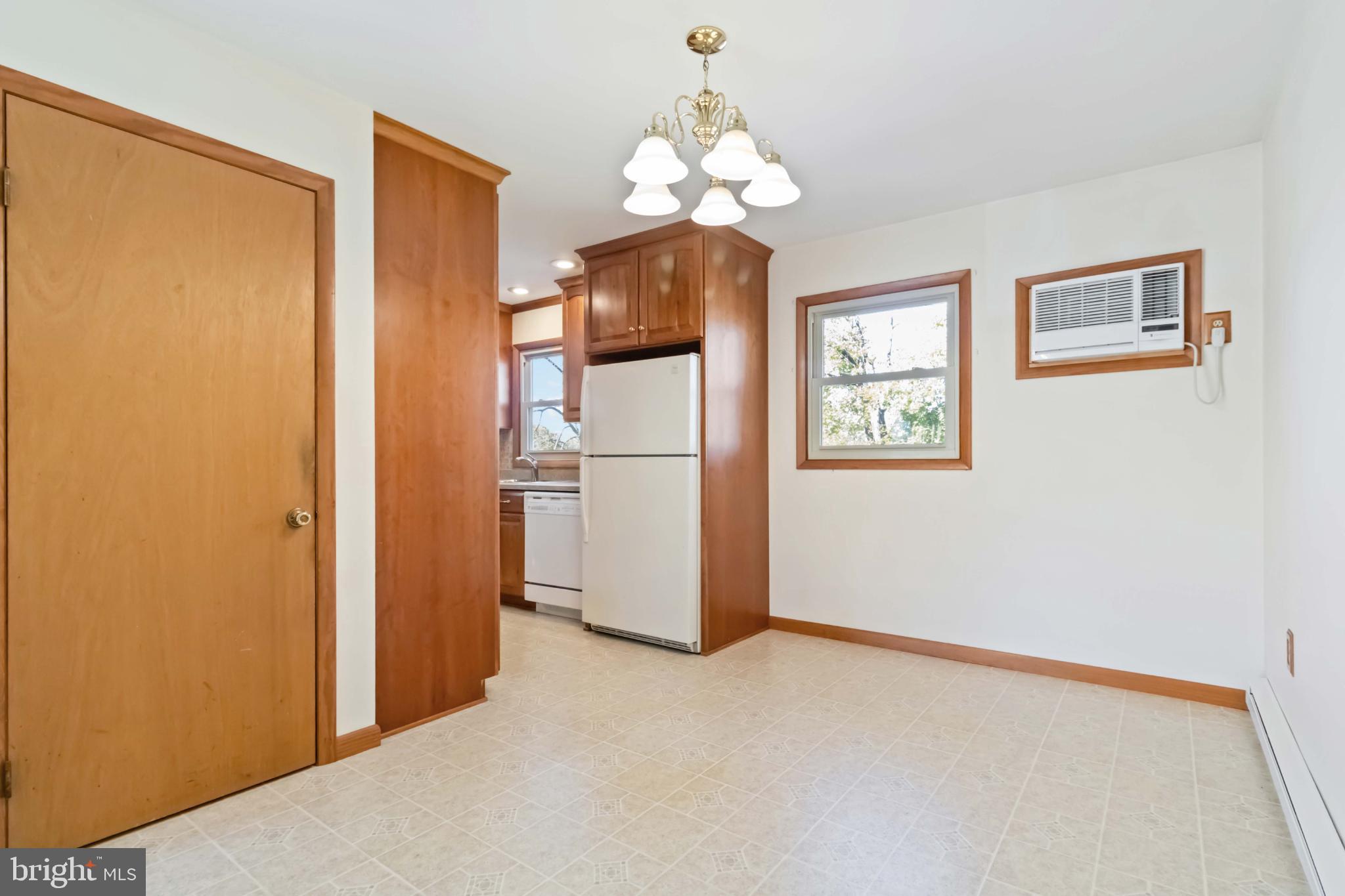 6216 Blue Grass Avenue Harrisburg, PA 17112 - Photo 9 of 23 a view of a room with wooden floor chandelier and a refrigerator