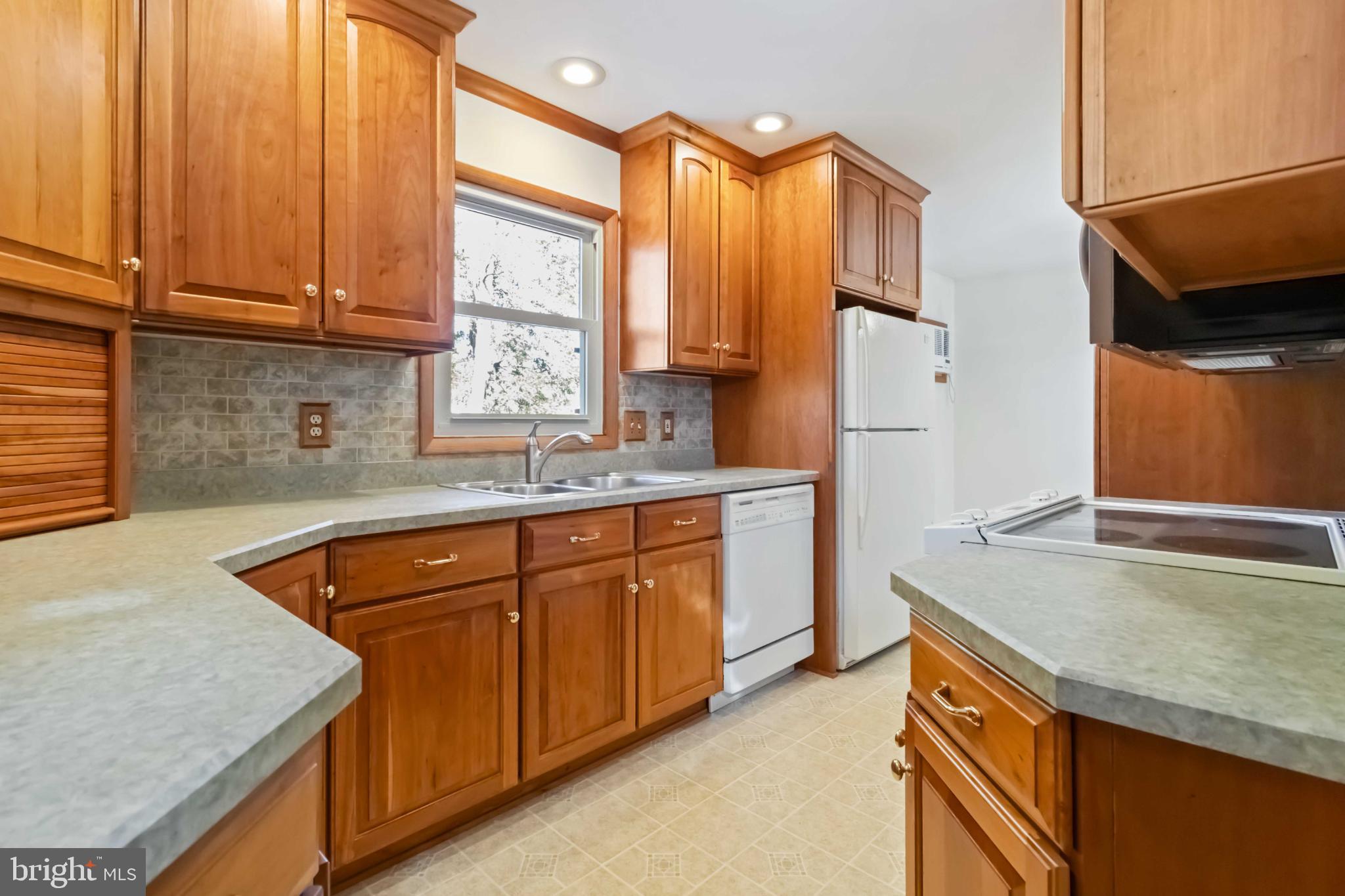 6216 Blue Grass Avenue Harrisburg, PA 17112 - Photo 10 of 23 a kitchen with stainless steel appliances granite countertop a sink a stove and a refrigerator
