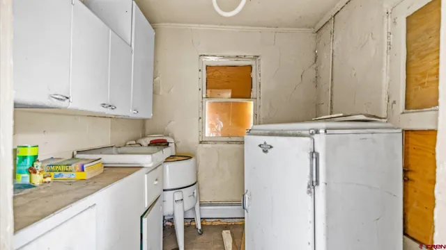 a kitchen with a refrigerator a sink and cabinets