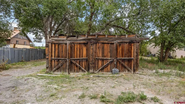 a view of backyard with wooden fence