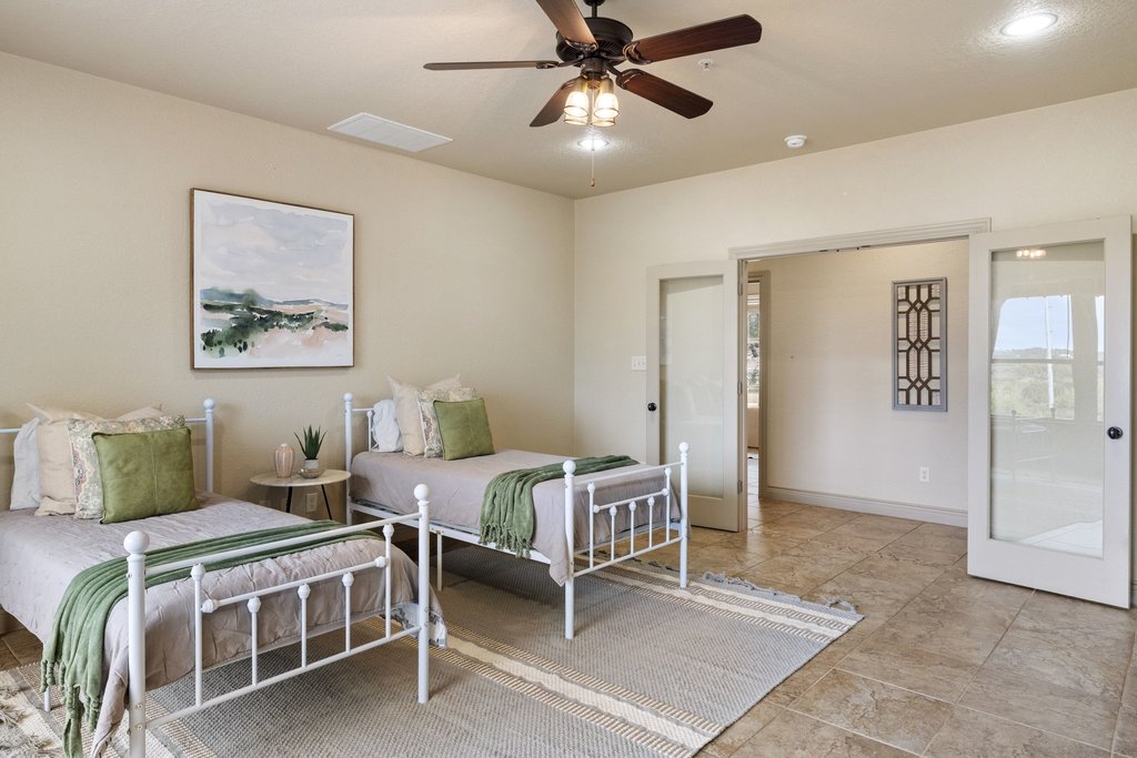 232 Crooked Oak Round Mountain, TX 78663 - Photo 26 of 40 Bedroom with ceiling fan and baseboards