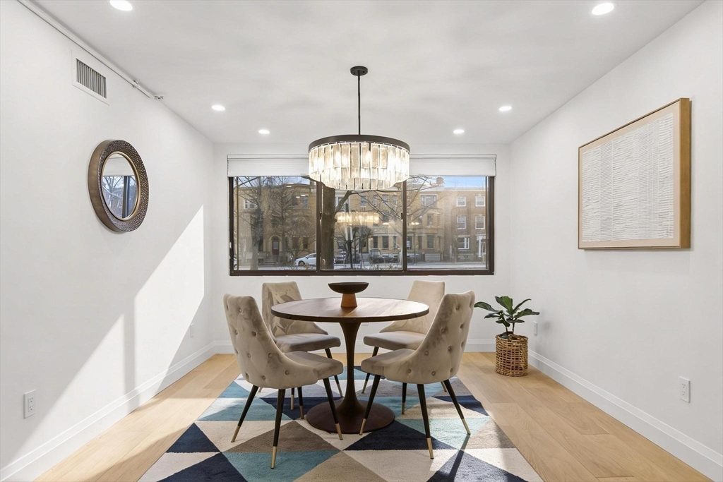 a dining room with furniture a rug and a window