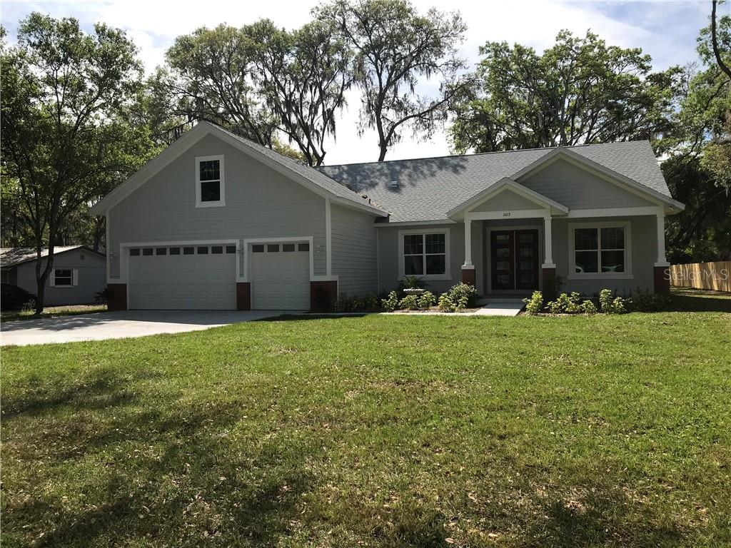 a front view of house with yard and outdoor seating