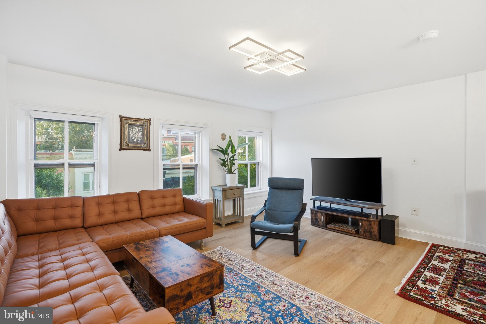 313 C Street Southeast Washington, DC 20003 - Photo 11 of 47 a living room with furniture and a flat screen tv