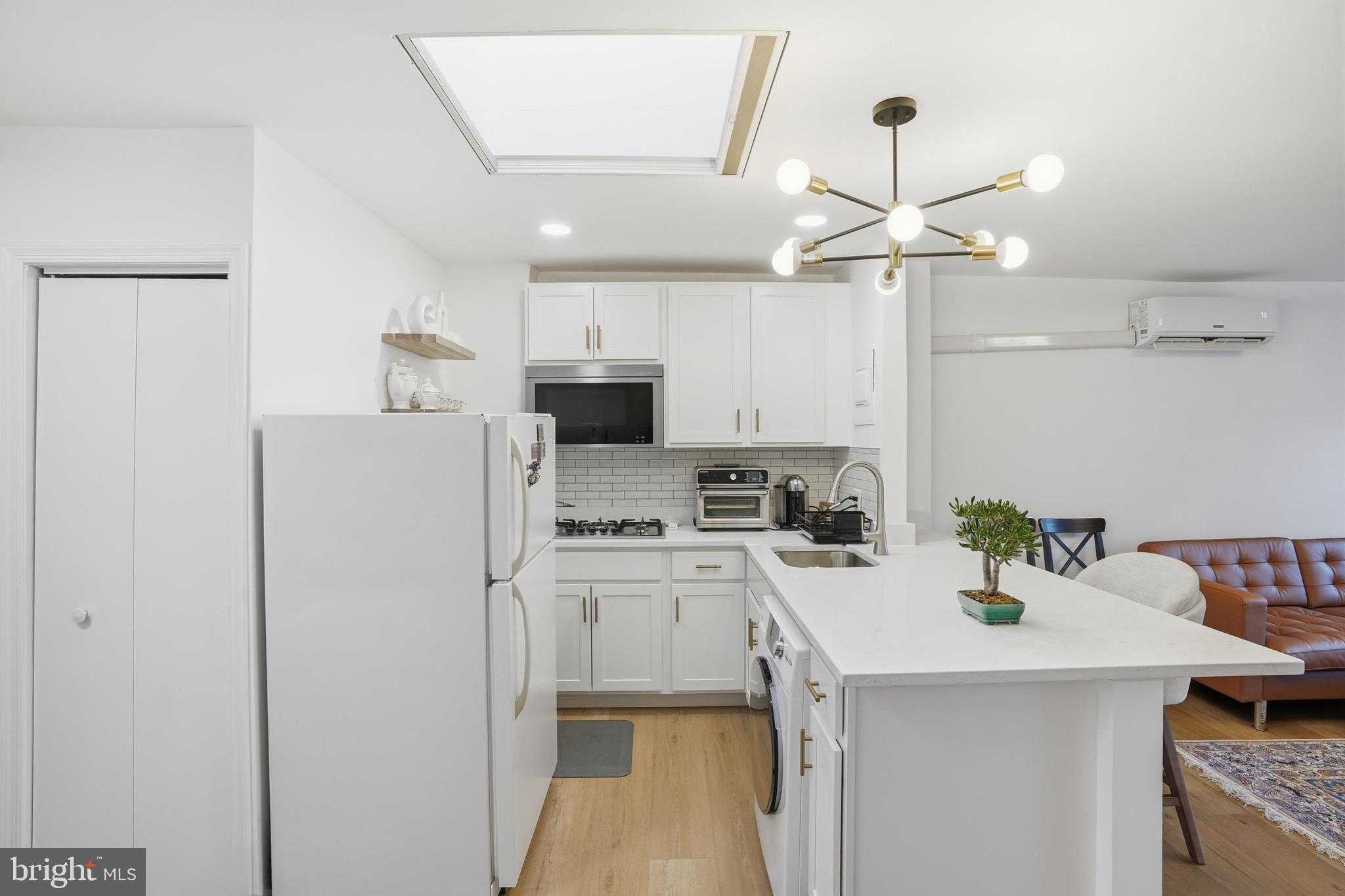313 C Street Southeast Washington, DC 20003 - Photo 2 of 47 a kitchen with a sink a refrigerator and chairs