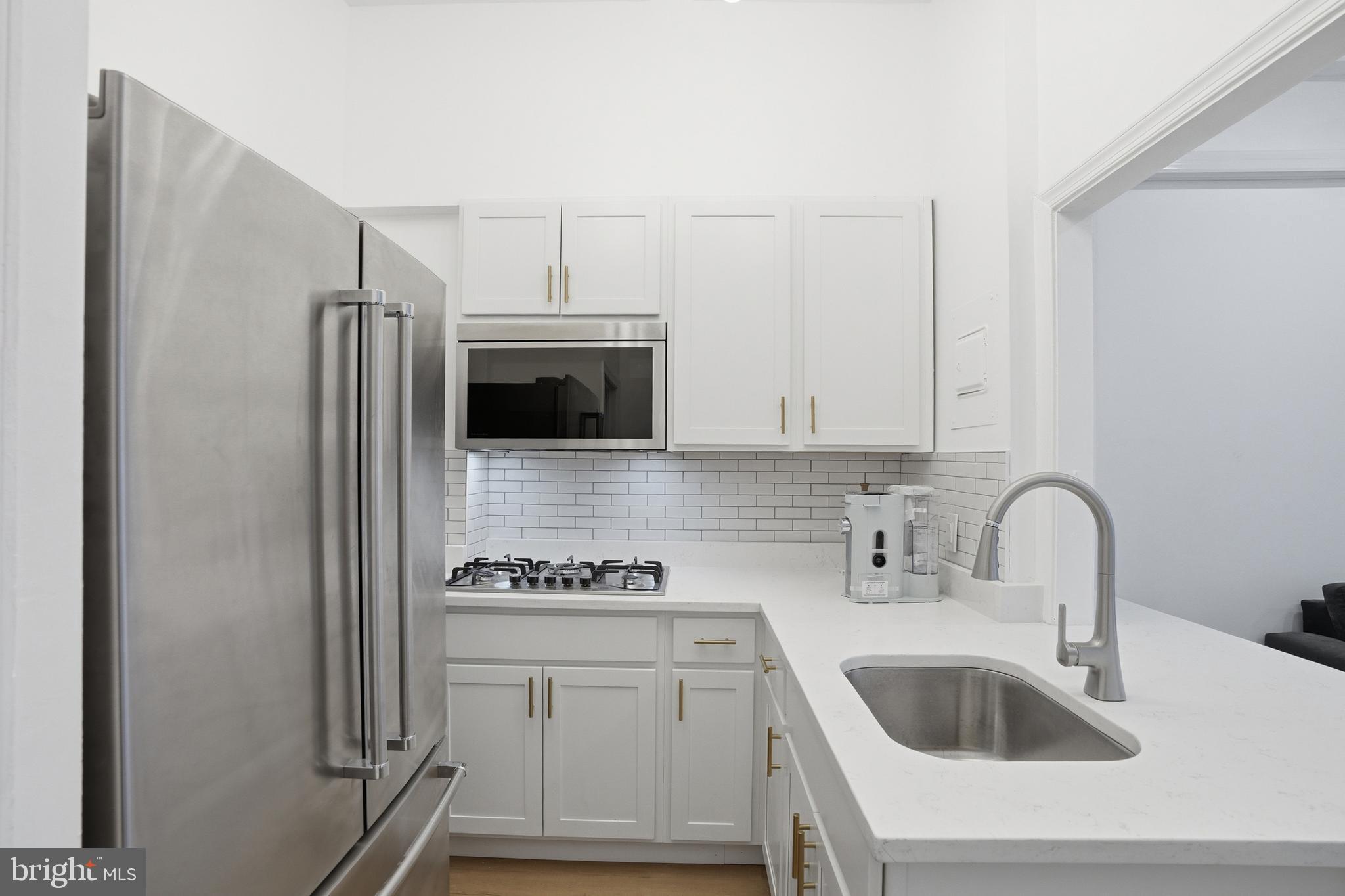 313 C Street Southeast Washington, DC 20003 - Photo 3 of 47 a kitchen with sink a microwave and refrigerator