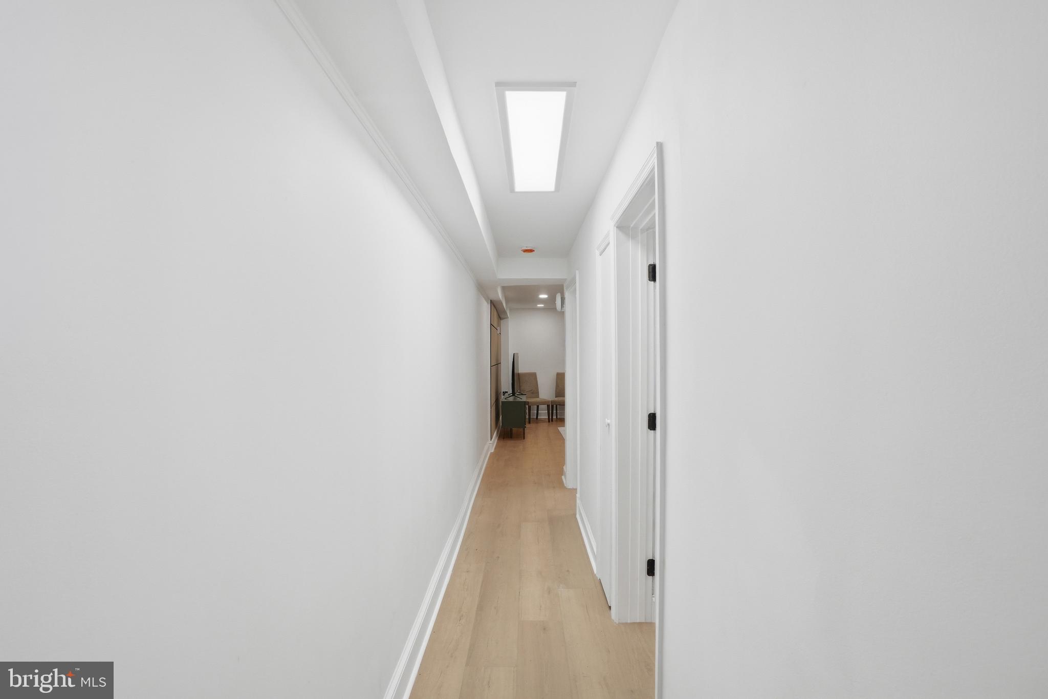 313 C Street Southeast Washington, DC 20003 - Photo 37 of 47 a view of a hallway with wooden floor and a white wall