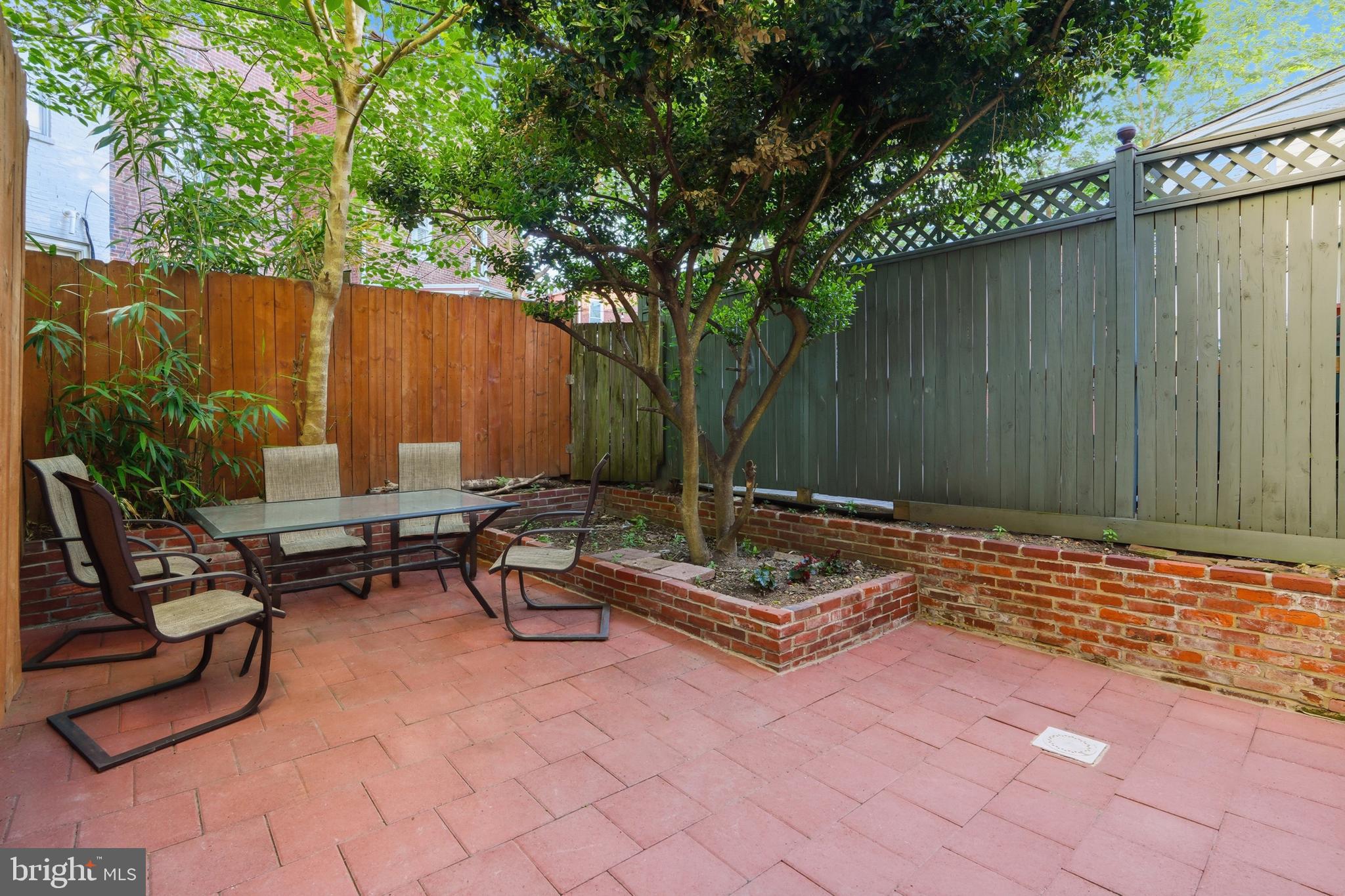 313 C Street Southeast Washington, DC 20003 - Photo 43 of 47 a backyard of a house with table and chairs