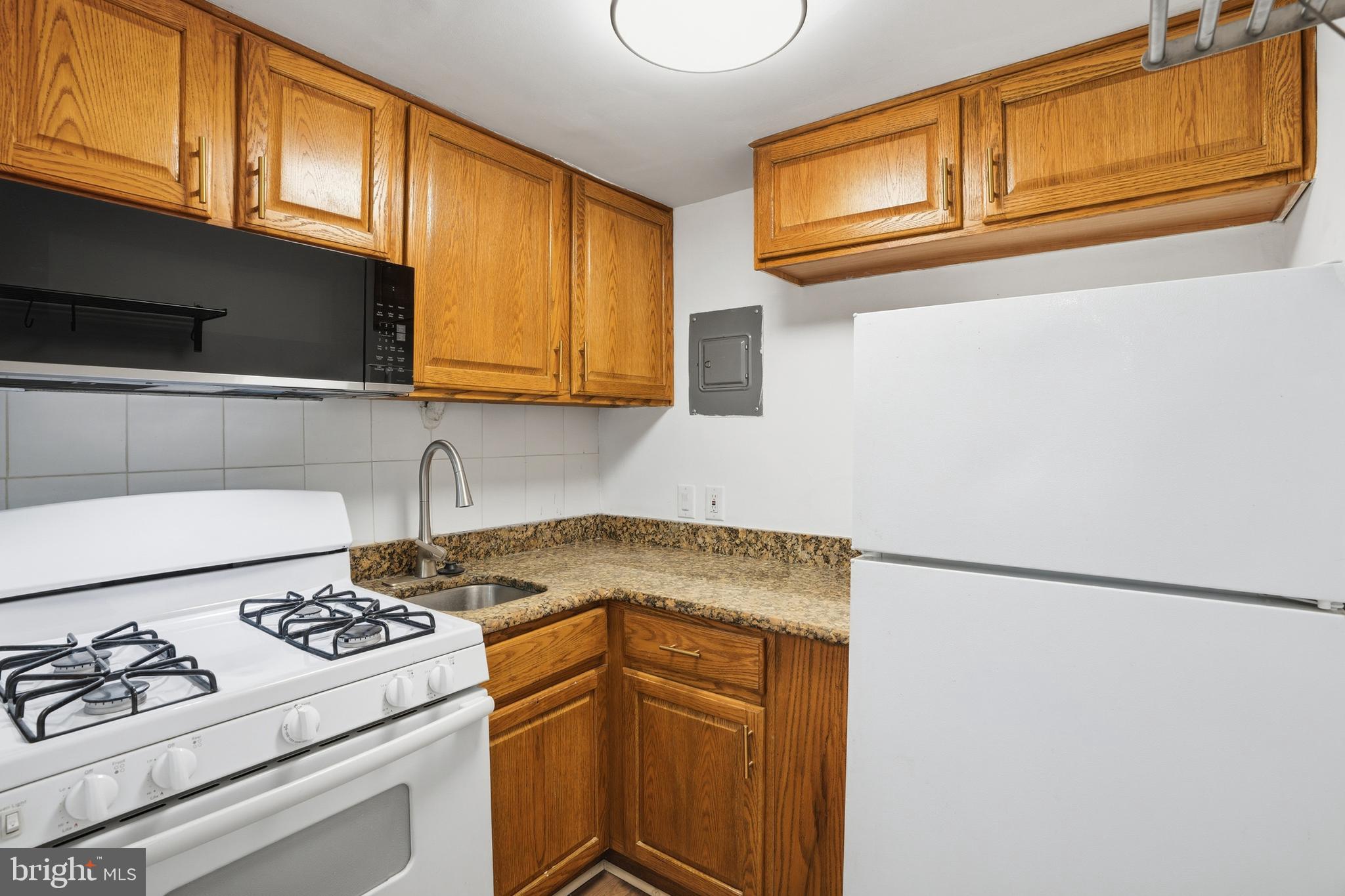 313 C Street Southeast Washington, DC 20003 - Photo 7 of 47 a kitchen with stainless steel appliances granite countertop a sink stove and refrigerator