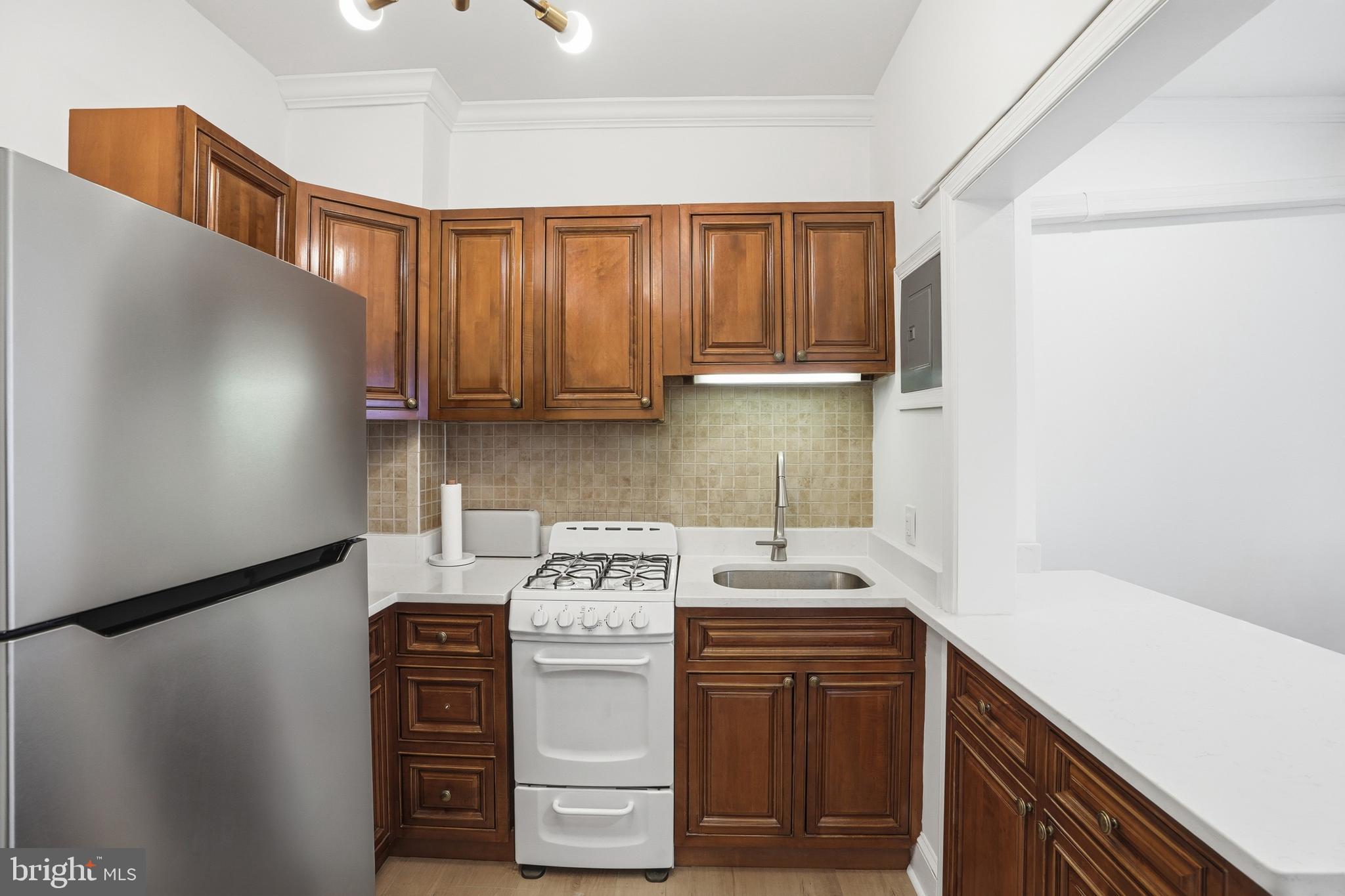 313 C Street Southeast Washington, DC 20003 - Photo 9 of 47 a utility room with cabinets washer and dryer