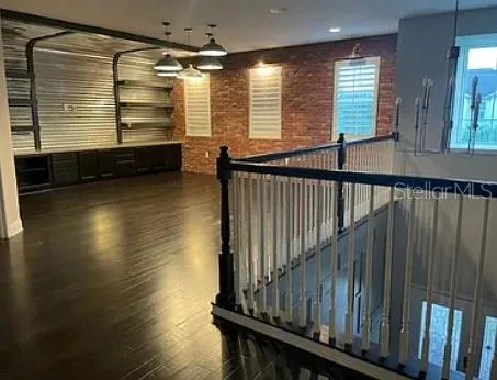 a view of a room with wooden floor and windows