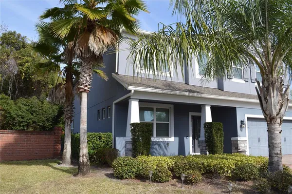 a front view of house with yard and green space