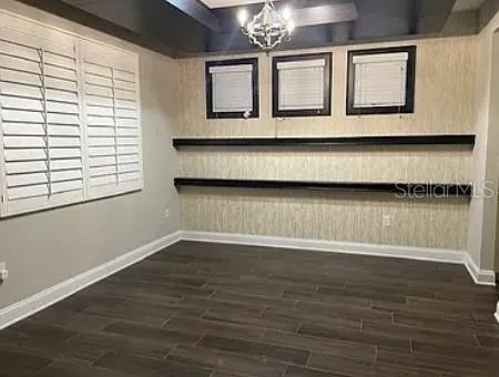 a view of wooden floor and windows in a room