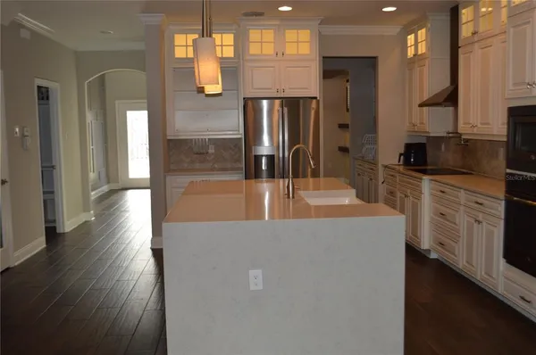 a kitchen with stainless steel appliances a refrigerator and a stove top oven