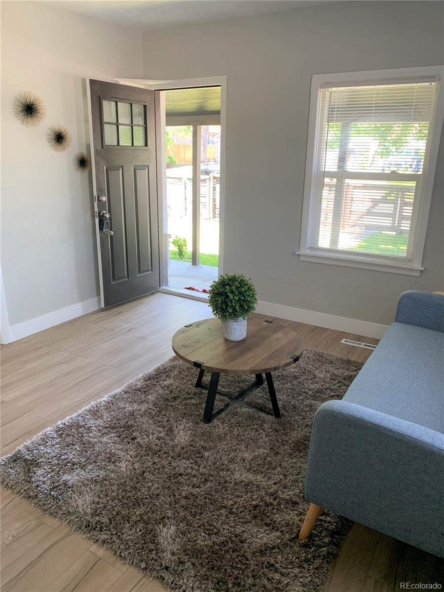 400 South Raleigh Street Denver, CO 80219 - Photo 3 of 23 a living room with furniture and a window