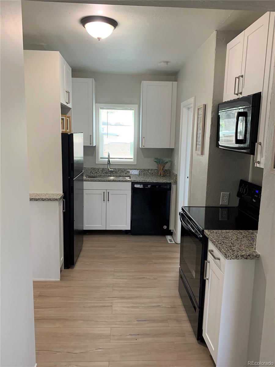 400 South Raleigh Street Denver, CO 80219 - Photo 5 of 23 a kitchen with stainless steel appliances granite countertop a refrigerator stove and sink