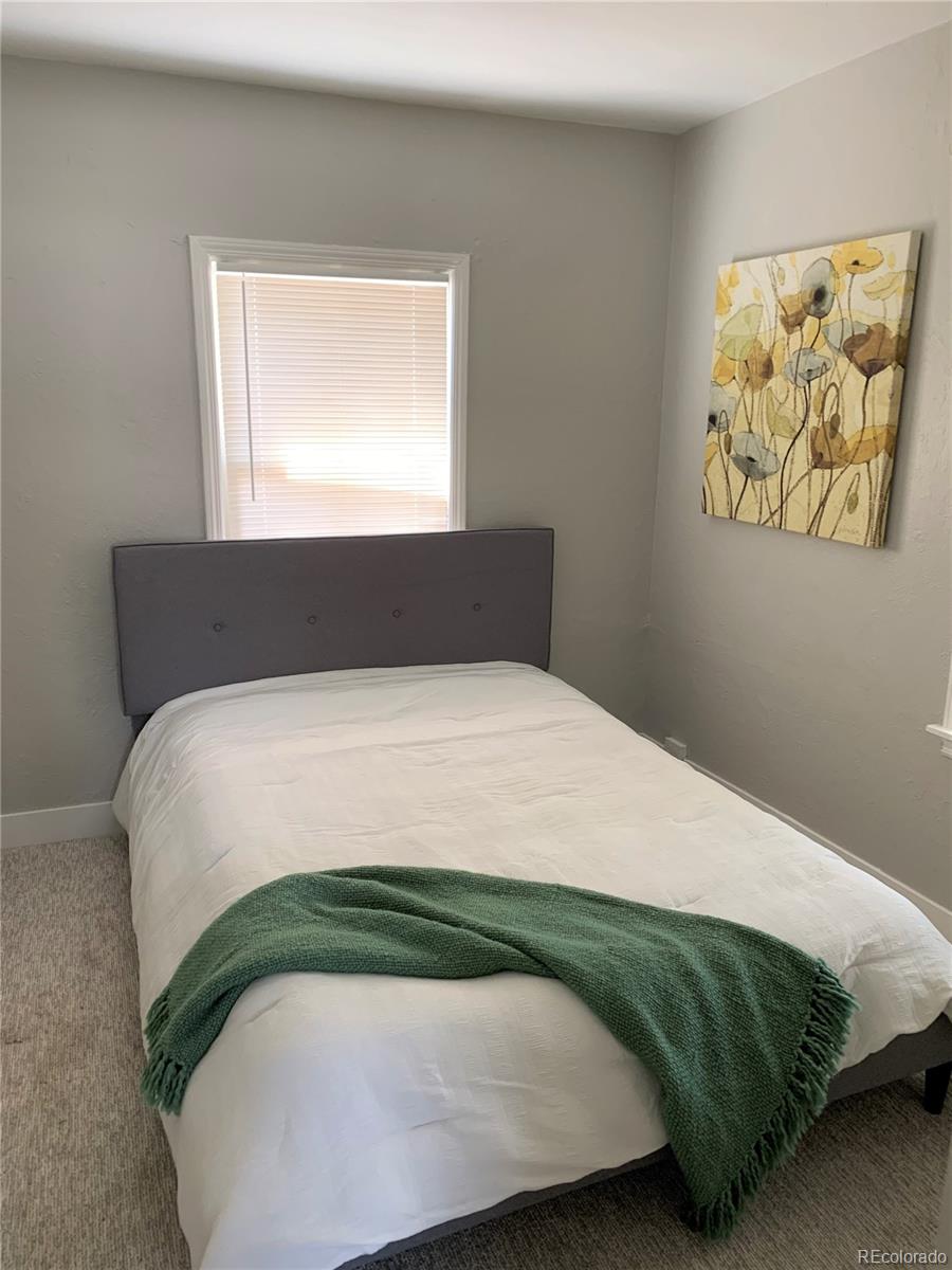 400 South Raleigh Street Denver, CO 80219 - Photo 7 of 23 a bedroom with a bed and window