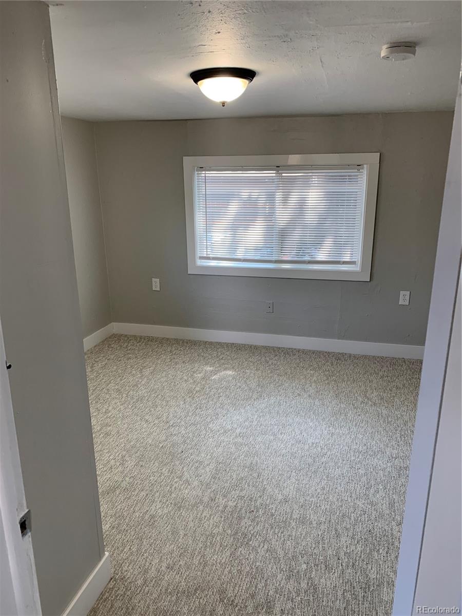 400 South Raleigh Street Denver, CO 80219 - Photo 8 of 23 an empty room with wooden floor and windows